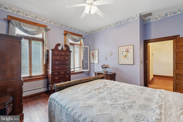 bedroom with ceiling fan, hardwood / wood-style floors, and a baseboard radiator