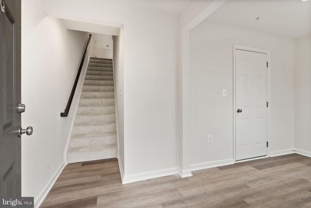 staircase featuring hardwood / wood-style flooring