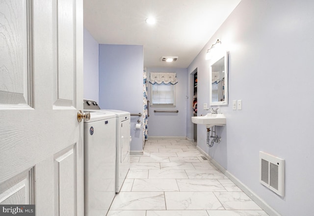 bathroom with washing machine and dryer and sink