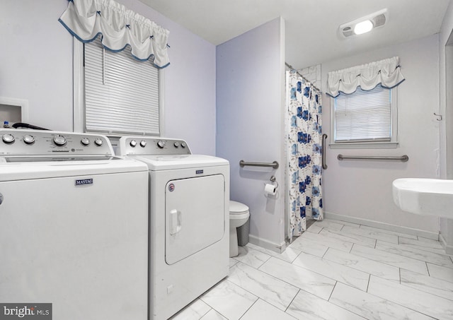 clothes washing area featuring washing machine and clothes dryer