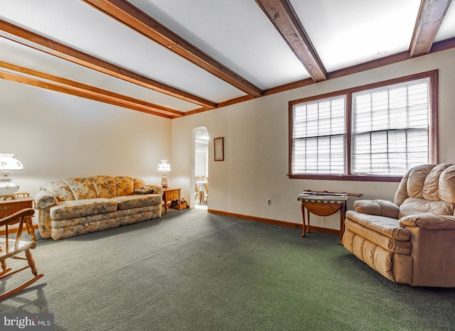 carpeted living room with beamed ceiling