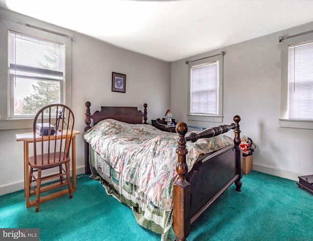 carpeted bedroom featuring multiple windows