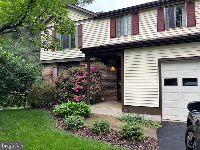 10712 Freds Oak Ct, Burke, VA 22015 - view of front facade featuring brick siding and an attached garage