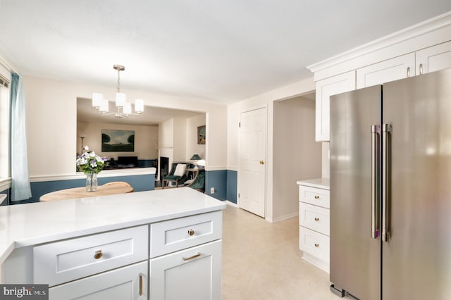 10712 Freds Oak Ct, Burke, VA 22015 - kitchen with high end fridge, a chandelier, light countertops, and white cabinets