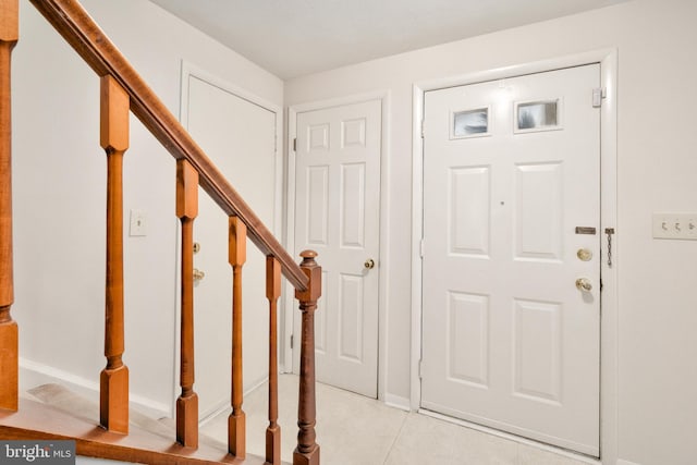 10712 Freds Oak Ct, Burke, VA 22015 - entrance foyer with stairway, light tile patterned flooring, and baseboards