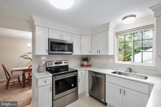 10712 Freds Oak Ct, Burke, VA 22015 - kitchen featuring appliances with stainless steel finishes, a sink, white cabinets, and light countertops