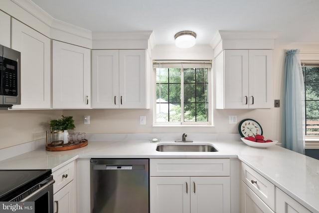 10712 Freds Oak Ct, Burke, VA 22015 - kitchen with appliances with stainless steel finishes, a sink, white cabinetry, and light countertops