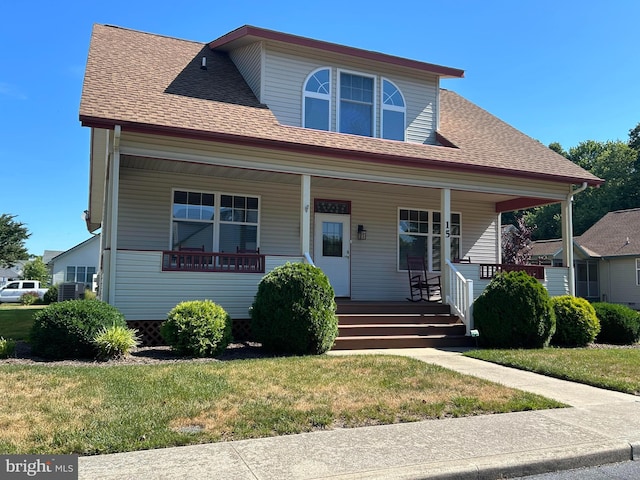 view of front of property featuring covered porch and a front yard