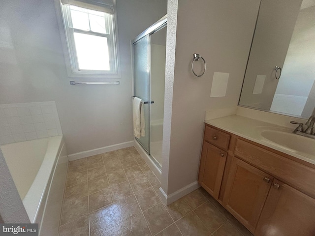 bathroom with vanity and shower with separate bathtub