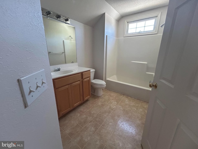 full bathroom featuring vanity, tub / shower combination, toilet, and a textured ceiling