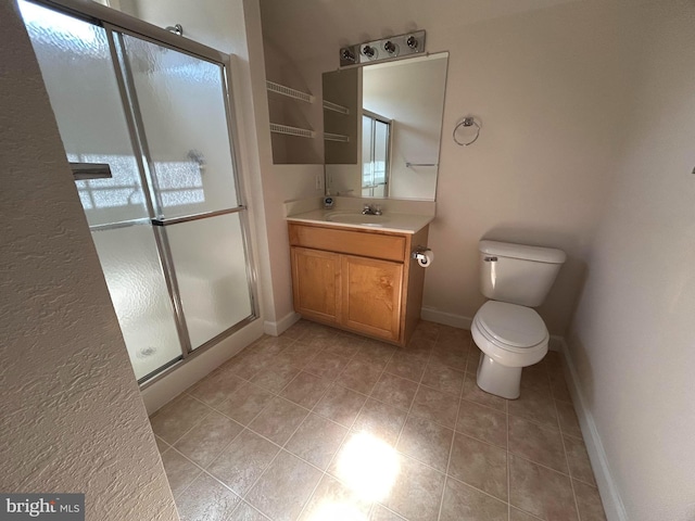 bathroom featuring a shower with door, vanity, and toilet