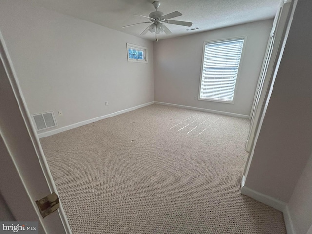 spare room with light carpet and ceiling fan