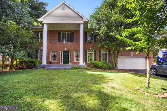 neoclassical home featuring a garage and a front lawn