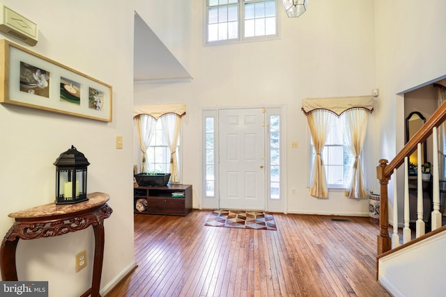 foyer entrance featuring a high ceiling and hardwood / wood-style flooring