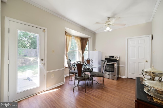 dining room featuring ceiling fan, a healthy amount of sunlight, and dark hardwood / wood-style floors