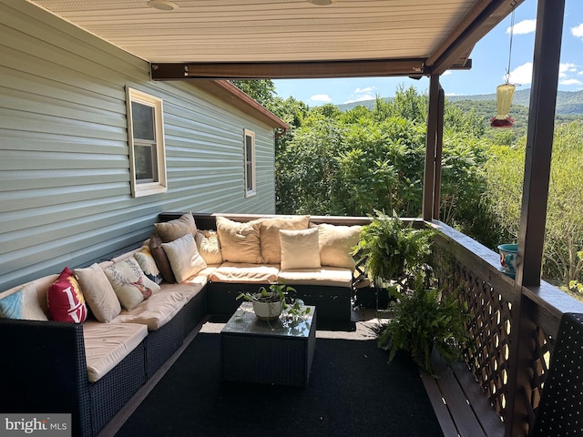 exterior space featuring ceiling fan and an outdoor living space