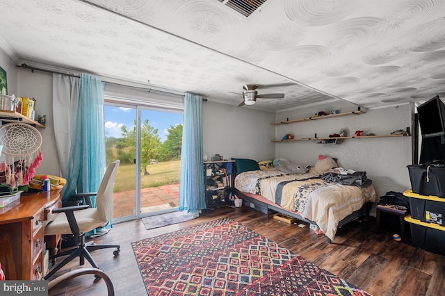 bedroom with hardwood / wood-style flooring, access to outside, and ceiling fan