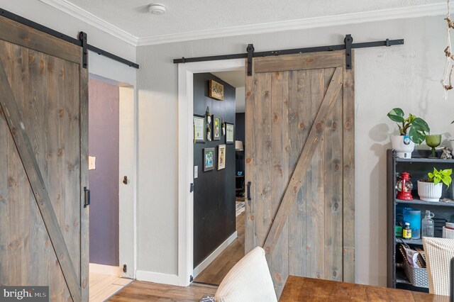 interior space featuring crown molding, a textured ceiling, and hardwood / wood-style floors