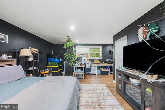 bedroom with hardwood / wood-style flooring