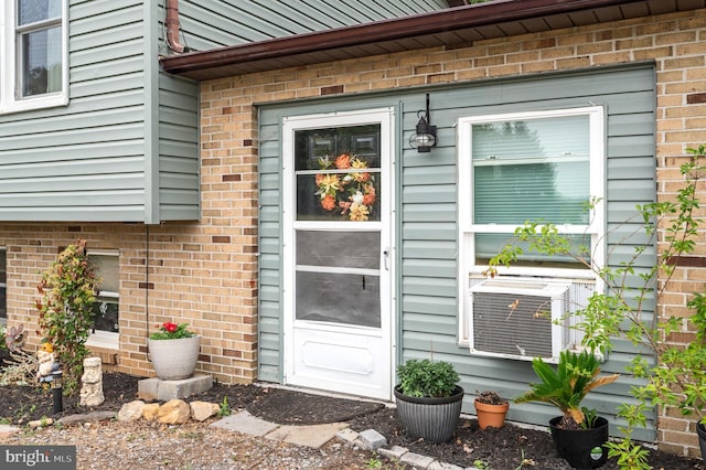 entrance to property featuring cooling unit