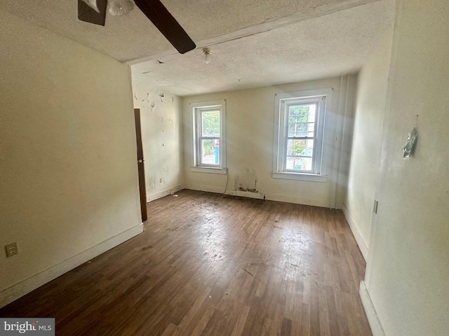 unfurnished room with ceiling fan, a textured ceiling, and hardwood / wood-style flooring