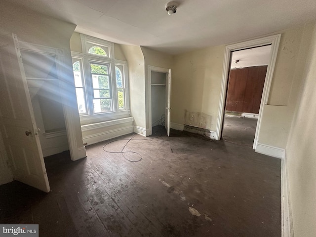 unfurnished bedroom featuring dark wood-type flooring