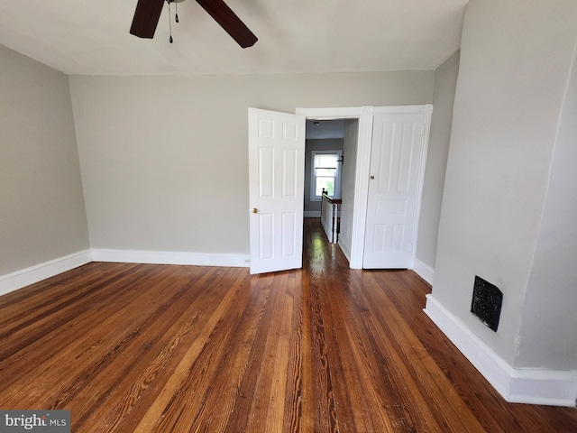 interior space featuring dark wood-type flooring and ceiling fan