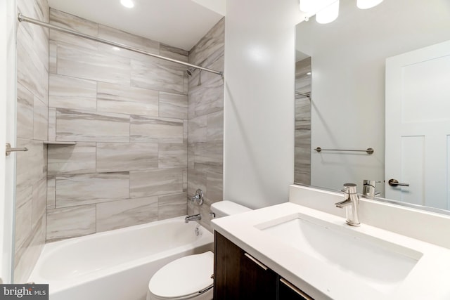 full bathroom featuring toilet, vanity, and tiled shower / bath