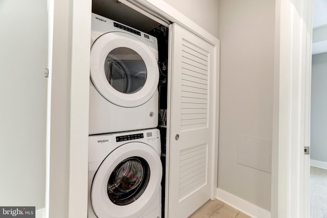 washroom featuring stacked washer / dryer