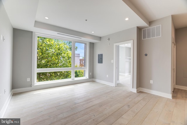 spare room with light wood-type flooring and electric panel