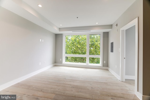 unfurnished room featuring light hardwood / wood-style floors and electric panel