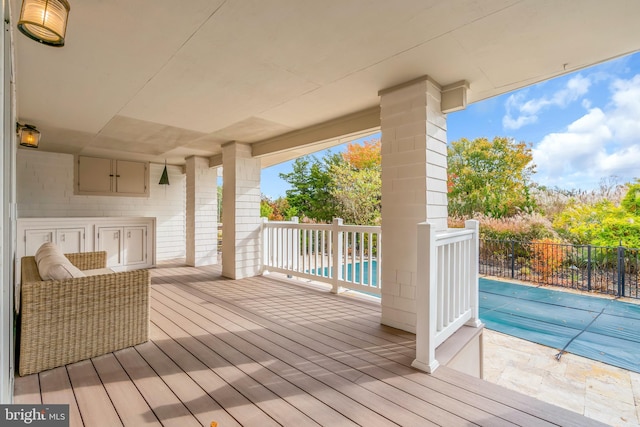 wooden terrace featuring a covered pool