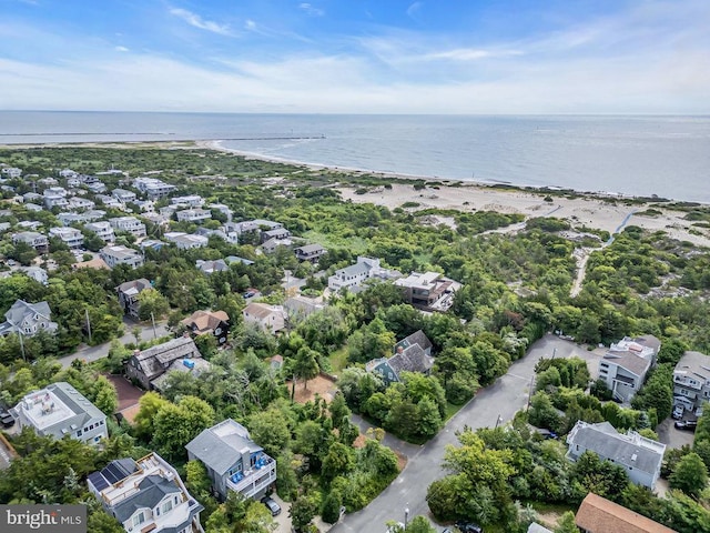 drone / aerial view with a water view and a beach view