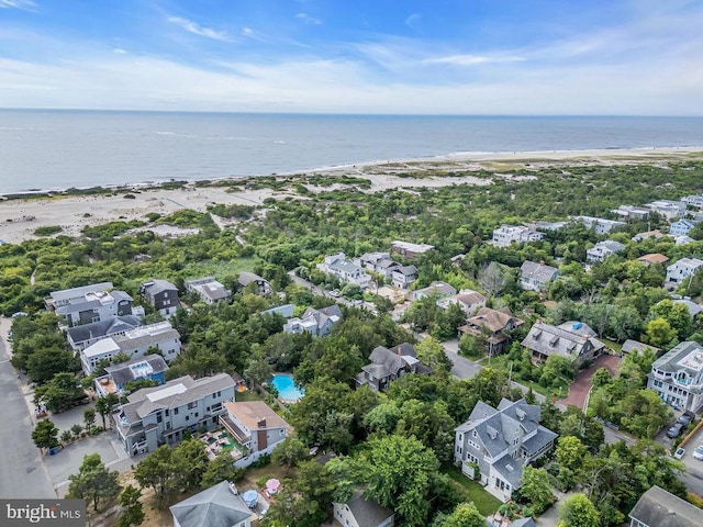 birds eye view of property with a view of the beach and a water view