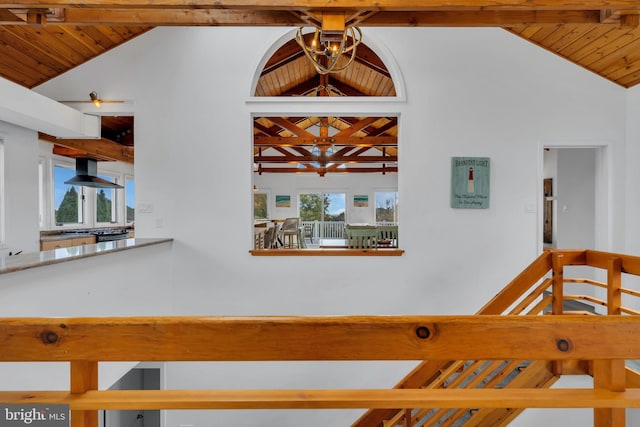 stairway with beamed ceiling, wood ceiling, and high vaulted ceiling