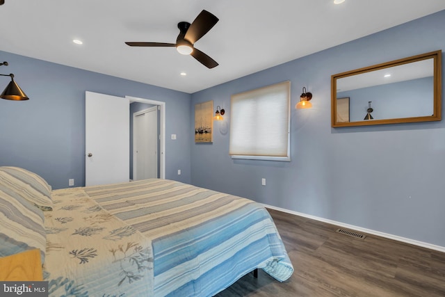 bedroom featuring ceiling fan and dark wood-type flooring