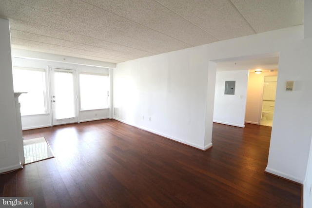 unfurnished room featuring dark wood-type flooring and electric panel