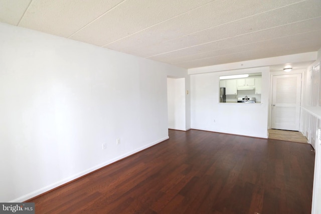 empty room featuring dark wood-type flooring