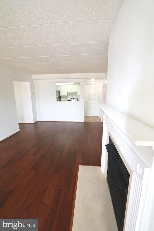 unfurnished living room featuring hardwood / wood-style flooring