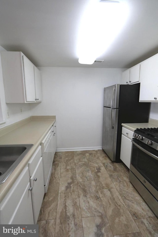 kitchen featuring white cabinetry, stainless steel range with gas cooktop, and white dishwasher