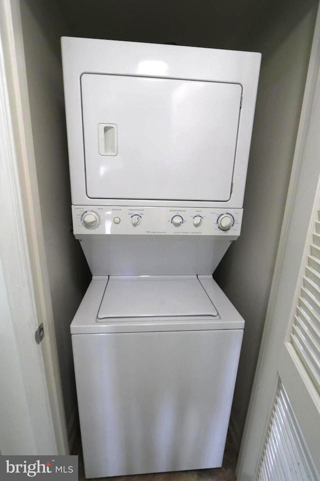 laundry room featuring stacked washer and clothes dryer