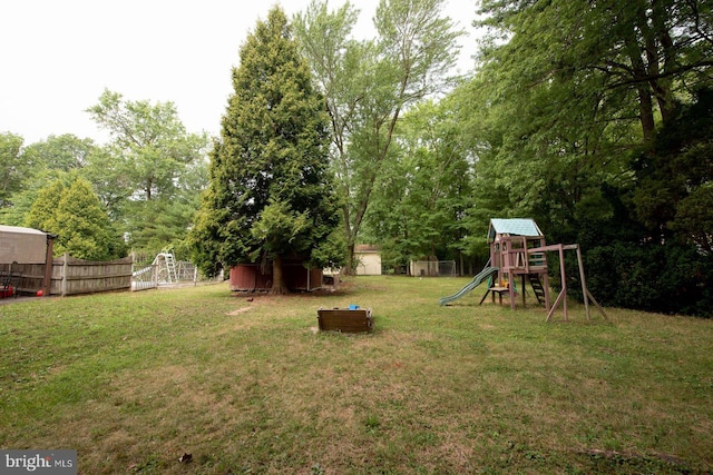 view of yard with a playground and a shed