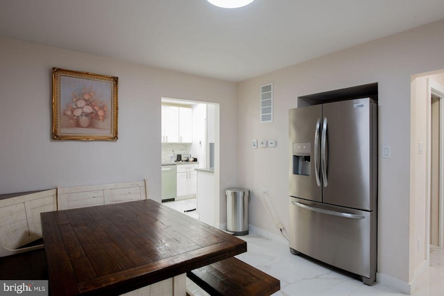 kitchen featuring stainless steel refrigerator with ice dispenser and white dishwasher