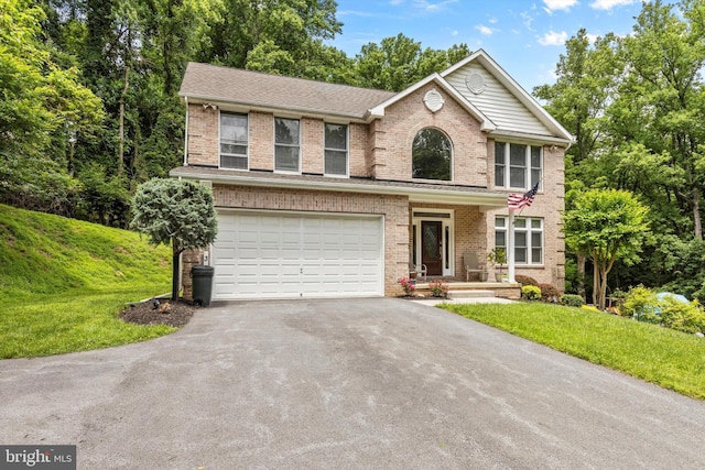 view of front of house with a garage and a front yard