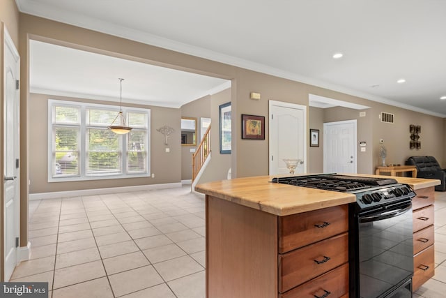 kitchen with black range with gas stovetop, crown molding, hanging light fixtures, light tile patterned floors, and butcher block countertops