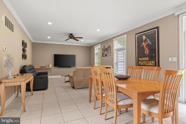 dining space with ceiling fan, light tile patterned floors, and ornamental molding