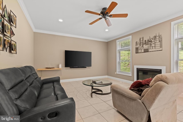 tiled living room with plenty of natural light, crown molding, and ceiling fan