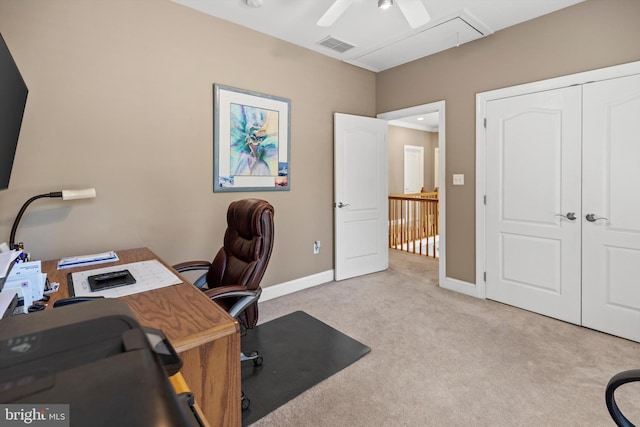 office space with ceiling fan and light carpet