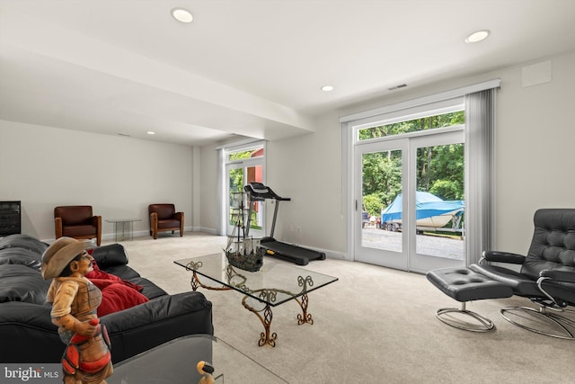 living room with french doors, carpet floors, and plenty of natural light