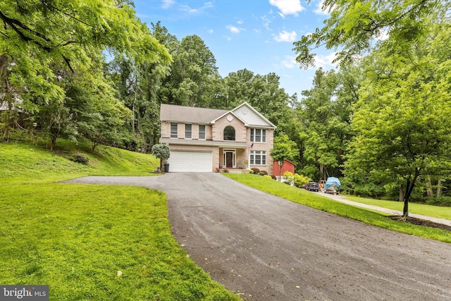 view of front of house featuring a garage and a front yard